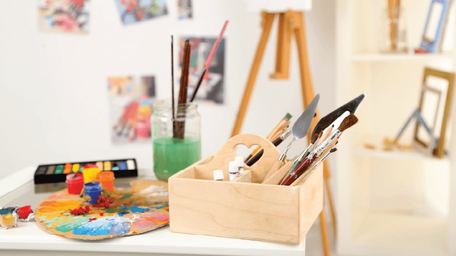 Recommended DIY craft workshop POS system eRunlite, showing art supplies including paintbrushes, palette, and paints on a table, featuring BOM inventory automation and cost analysis.